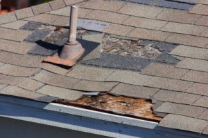 Close Up of a Residential Shingle Roofing System Damaged by Wind
