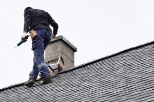 A roofing contractor installing a roof on a home